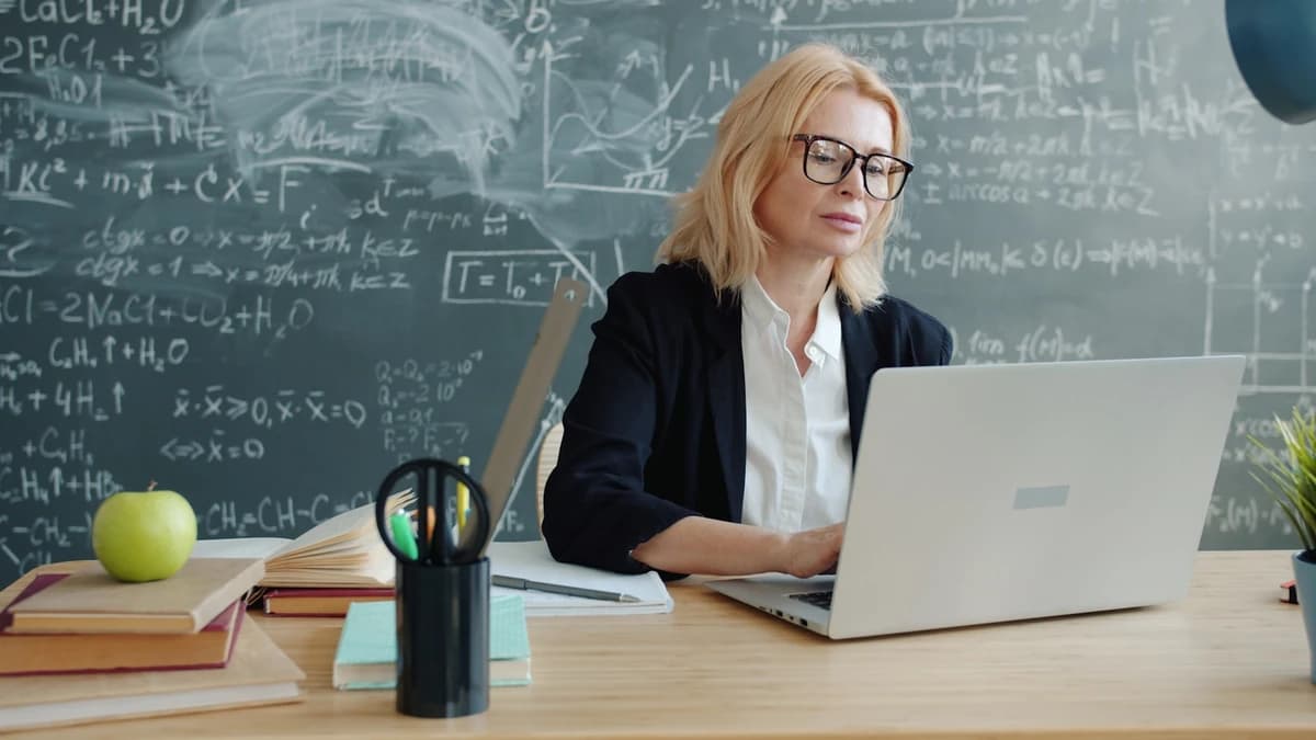 An instructor building next week's lesson at a chalkboard desk