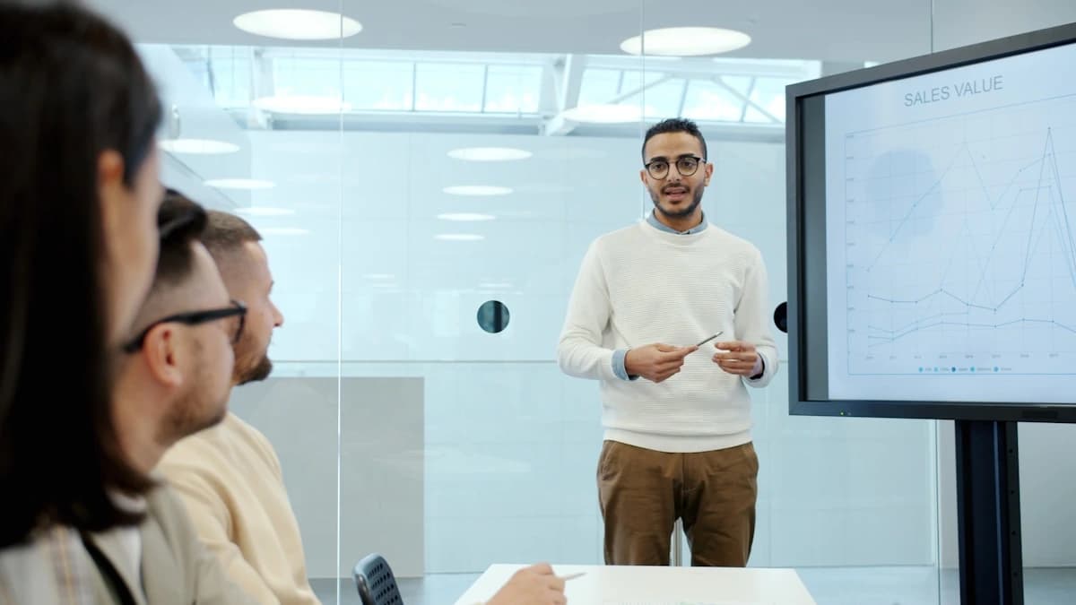 Vorapix use case — an in-house comms lead walking colleagues through a chart on the meeting room screen