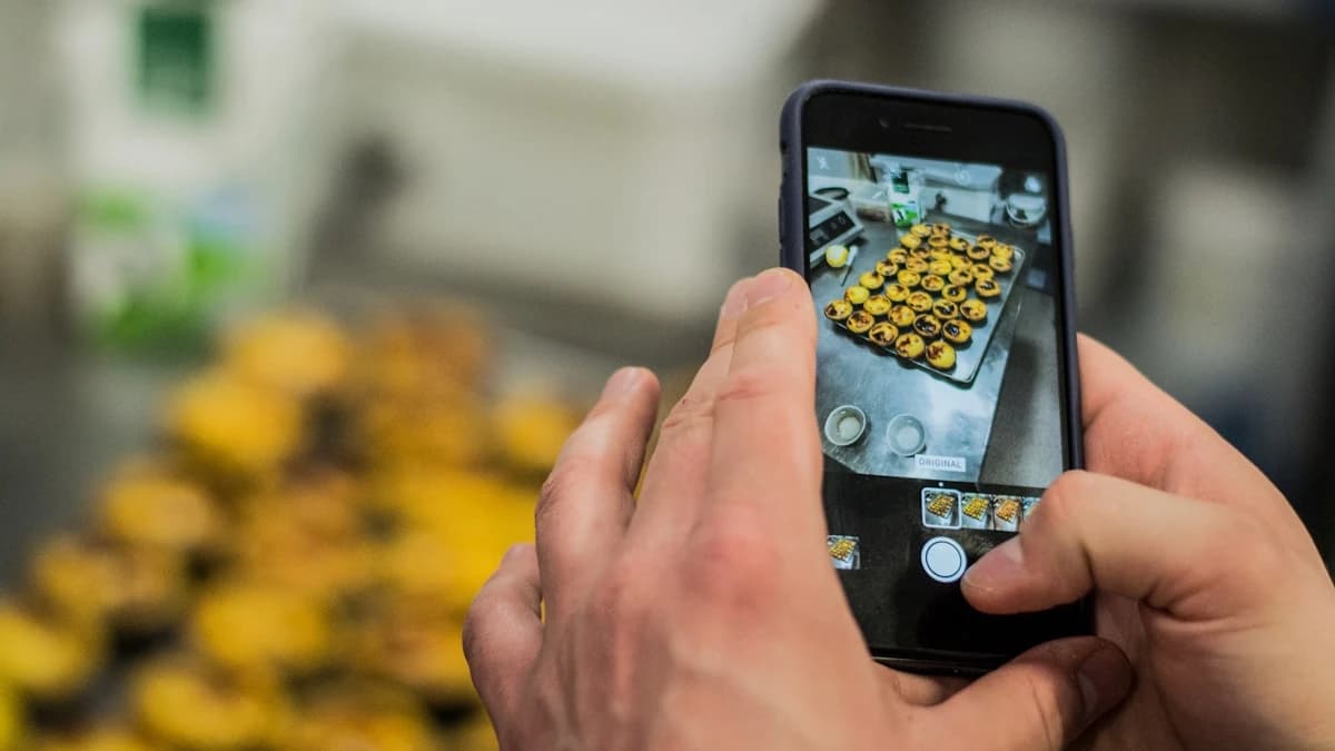 Vorapix use case — a solo brand owner photographing a fresh tray of pastries with a phone in their own kitchen