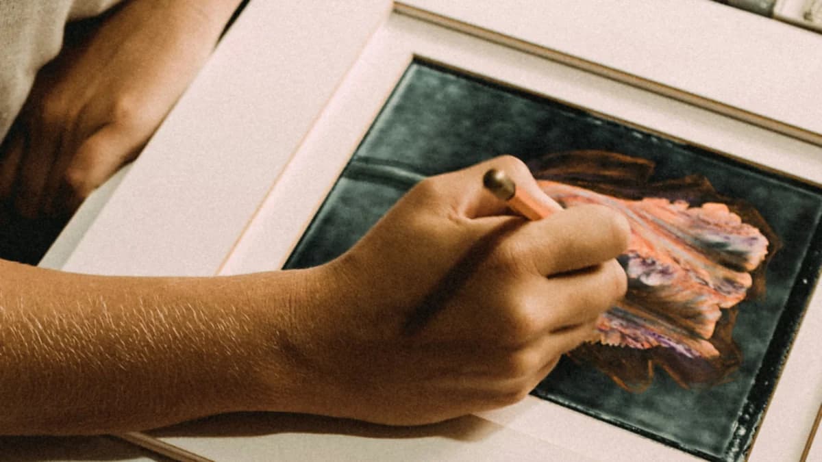 Retouching a mounted picture at a framing bench