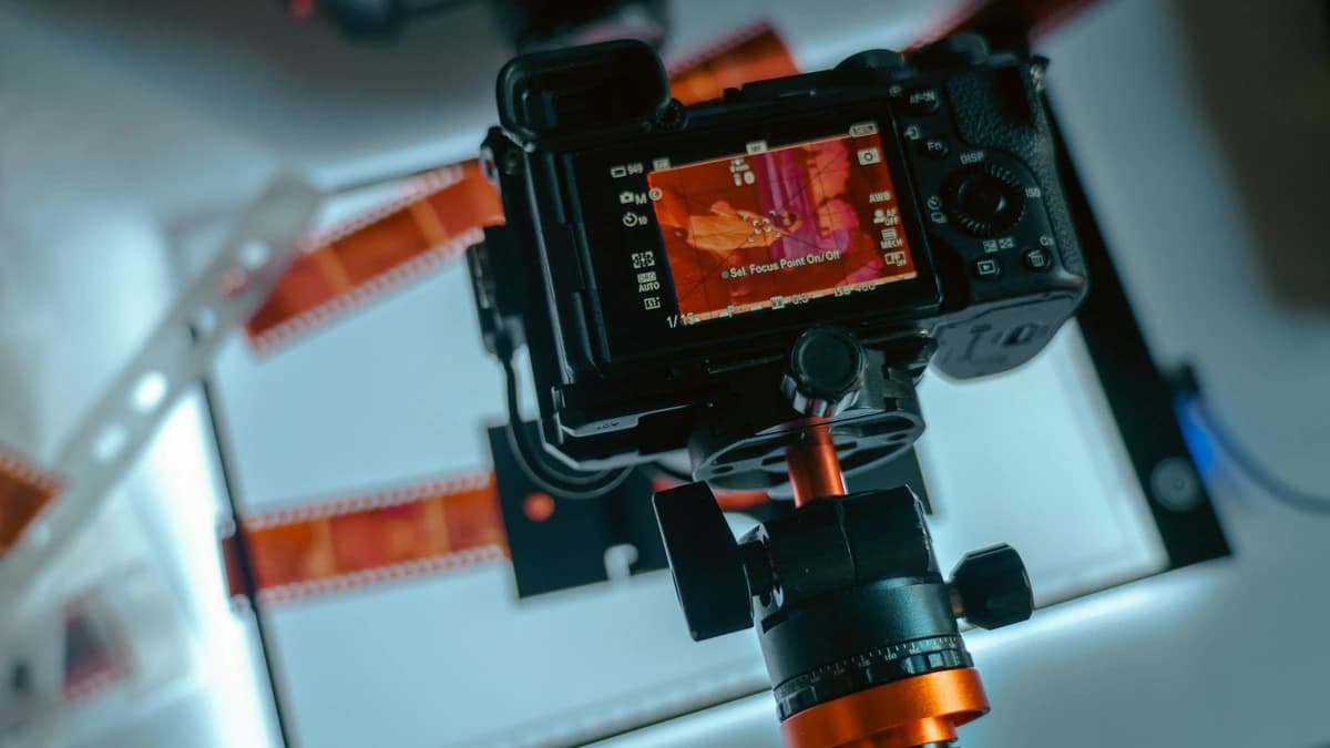 A camera digitising film negatives on a light table