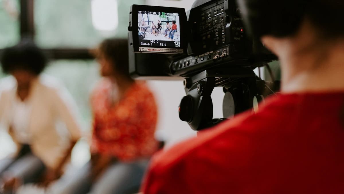 A camera operator recording a lesson segment on set