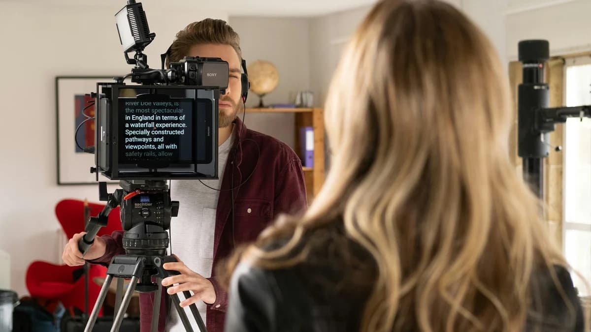 A camera operator filming a presenter on set