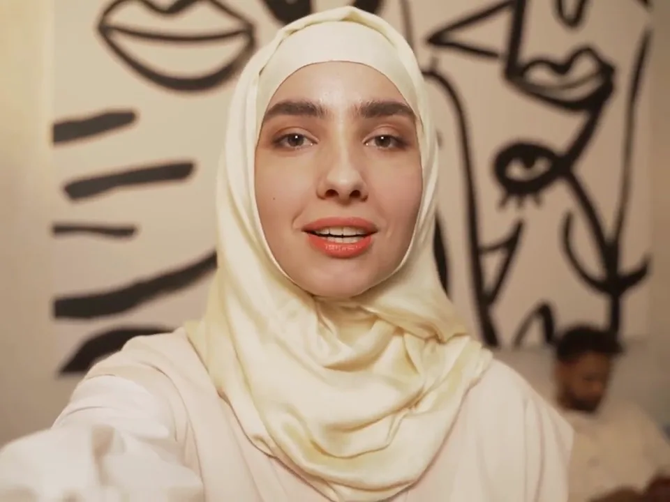 A speaker filmed against a mural loaded into the panel
